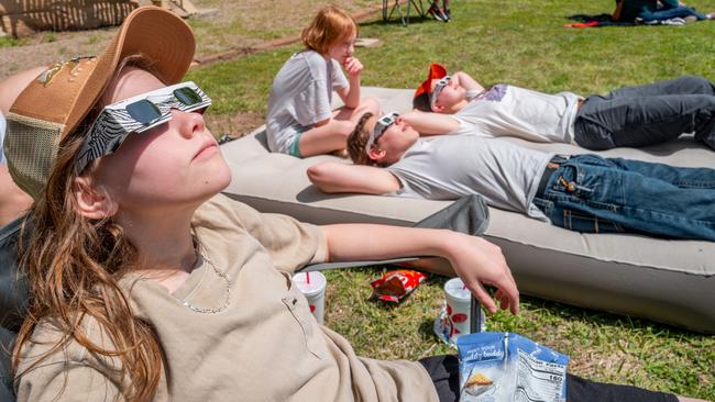 The Coleman family watches the sky minutes before the eclipse on in Brady, Texas. Picture: Brandon Bell/Getty Images