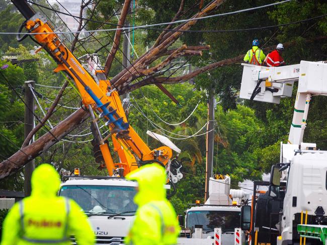 Energex crews clear a fallen tree following the passage of tropical cyclone Alfred in Brisbane on March 8, 2025. Picture: Patrick Hamilton/ AFP