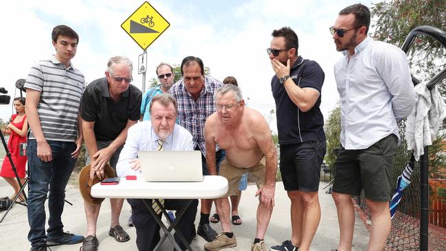 Goodna residents and local MP Paul Tully listen to the flood judgment. Picture: Peter Wallis