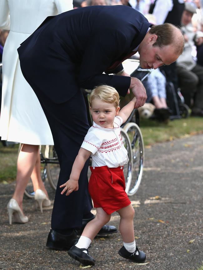 Britain’s Prince William, Duke of Cambridge and Prince George of Cambridge leave Princess Charlotte of Cambridge’s Christening at St. Mary Magdalene Church in Sandringham, England, on July 5, 2015. Picture: AFP