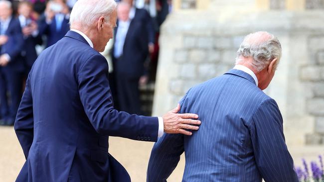 US president Joe Biden places his hand on the back of King Charles III as they walk in the Quadrangle after ceremonial welcome at Windsor Castle in Windsor. Picture: AFP