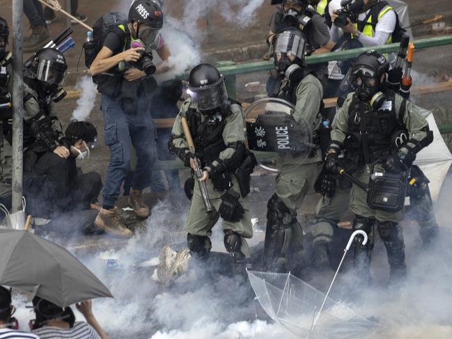 Riot police detain protesters amid clouds of tear gas at the Hong Kong Polytechnic University in Hong Kong. Picture: AP