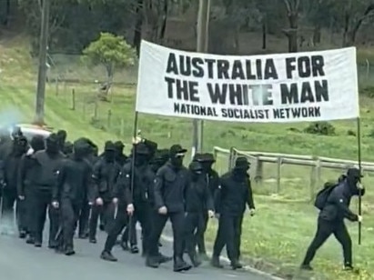 ADELAIDE, AUSTRALIA - NewsWire Photos, DECEMBER 18, 2023. Screen grabs from supplied viedo. A motel in a quiet Adelaide suburb has been targeted by neo-Nazis who staged a protest in broad daylight.  Six members of the neo-Nazi group Nationalist Socialist Network were captured on video walking down Main North Rd in the northernAdelaide suburb of Pooraka on Sunday before stopping at the Pavlos Motel. The balaclava-clad men were then seen performing Sieg Hail salutes, also known as Nazi or Hitler salutes, in the carport ofthe motel while being led through chants by a man carrying a megaphone.  Picture : NCA NewsWire