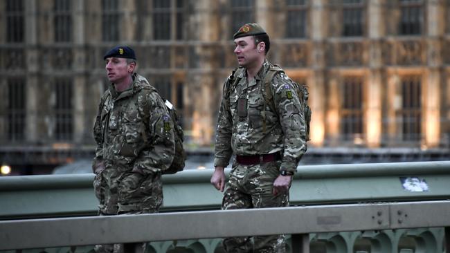 Members of the military cross an empty Westminster Bridge in London. Picture: AP.