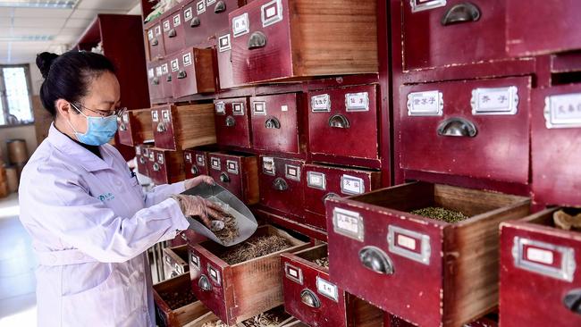 A medical worker taking a prescription of traditional Chinese medicine at a hospital in Shenyang in China's northeastern Liaoning province. Picture: AFP