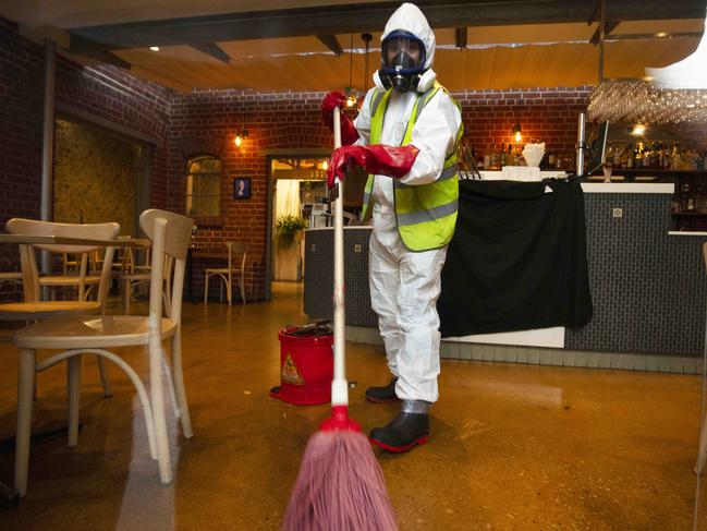 A cleaner conducts the deep clean of the Greek on Halifax Street, Adelaide. Picture: Emma Brasier.