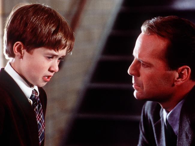 2000 : Actors Haley Joel Osment (L) & Bruce Willis in scene from 1999 film "The Sixth Sense".Osment/ActorWillis/Actor