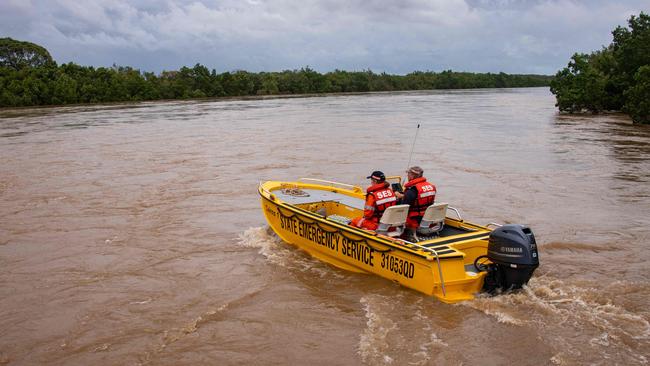 Emergency workers set out to evacuate stranded residents in Cairns following heavy flooding last December. Picture: AFP