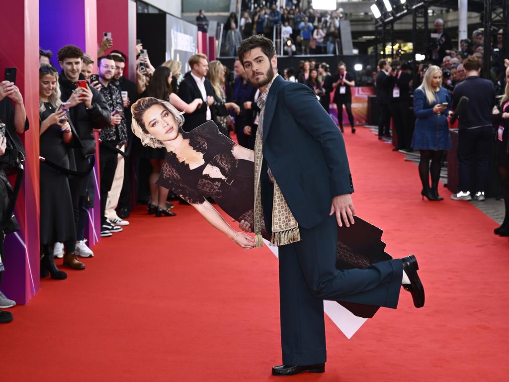 Clearly committed to his bit, Garfield takes a cardboard Florence Pugh out for a dance on the red carpet. Picture: Gareth Cattermole/Getty Images for BFI