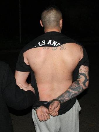 A Hells Angels member being arrested by Raptor officers. The gang has a small presence in Australia, but rides off a global reputation.