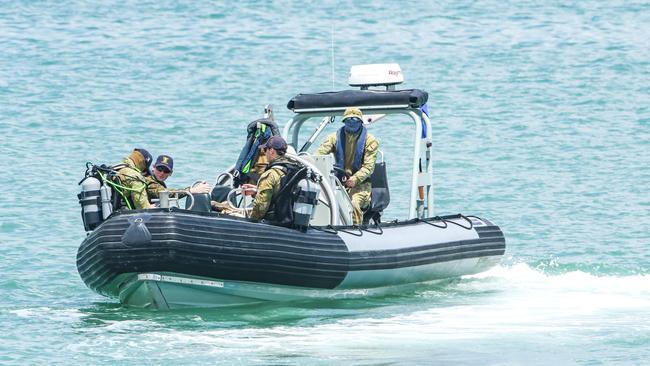 ADF divers work on recovering a World War II era bomb from Darwin Harbour at the site of the proposed ship lift. Picture: Glenn Campbell