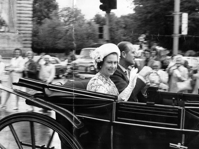 The Queen and Prince Philip leave Government House in a horse-drawn Landau vehicle.