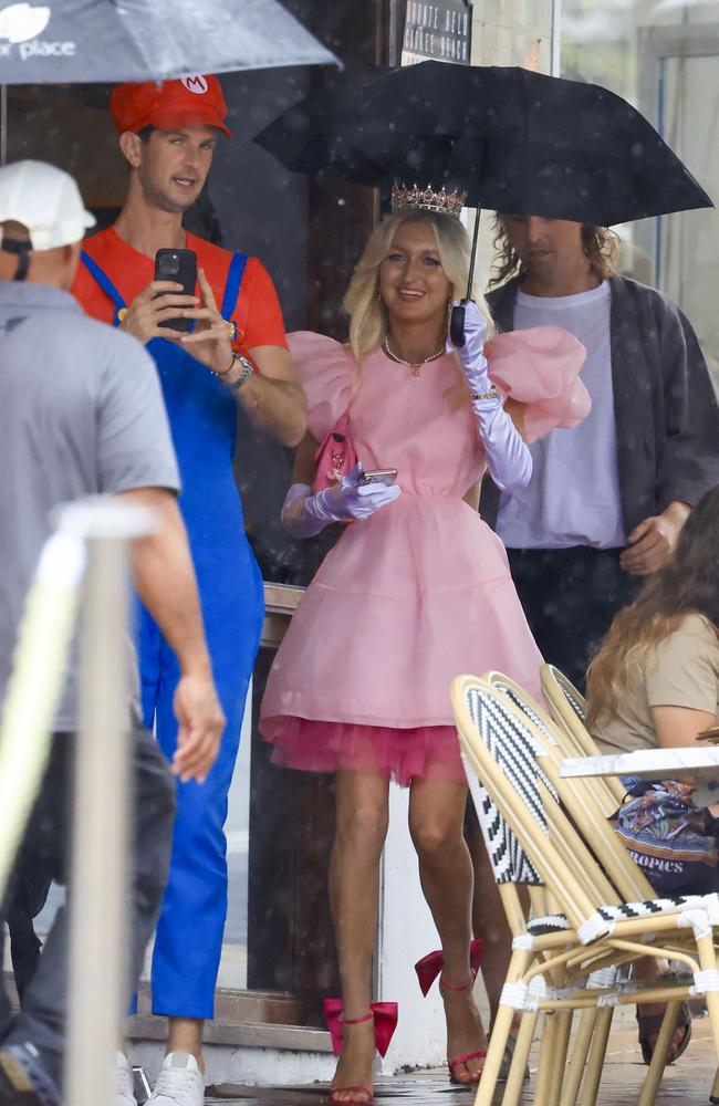 Various guests battled the rain as they made their way into the eastern suburbs restaurant. Picture: Media Mode