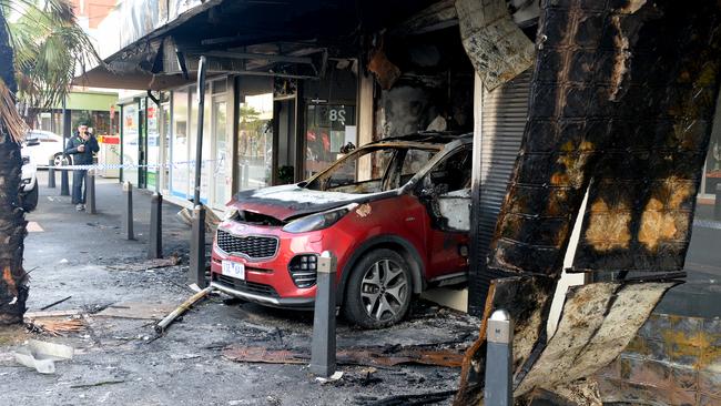 A burnt out car inside a tobacconist on Station Street Oakleigh. Picture: Andrew Henshaw