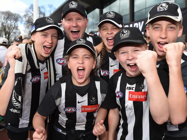 MELBOURNE, AUSTRALIA - NewsWire Photos, OCTOBER 1, 2023. AIA Vitality Centre Oval - Collingwood Family Day where Collingwood players are presented to fans after winning the AFL Grand Final yesterday. (L-R) Daisy Robinson, Glen Cochrane (back), Sadie Robinson, Elsie Robinson, Riley Cochrane and Henry Robinson. Picture: NCA NewsWire / Josie Hayden