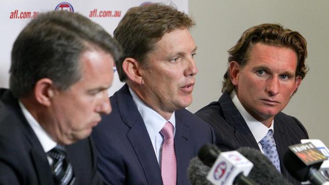 James Hird (right) faces the media with Ian Robson (left) and David Evans in 2013.