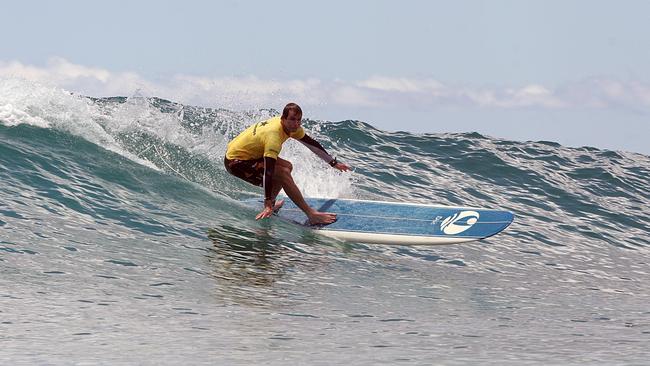 Dr Chuck Kelley surfing at Queens, Waikiki. Pic: Outrigger Group