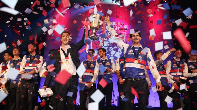 Bob Murphy and Easton Wood lift the cup again at the Melbourne Convention and Exhibition Centre.