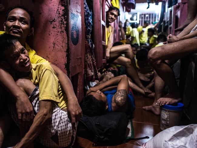 Inmates rest in their sleeping quarters inside the Quezon City jail at night. Picture: Ayee Macaraig