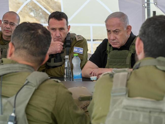 This handout picture released by the Government Press Office (GPO) shows Israel's Prime Minister Benjamin Netanyahu (R), Defence Minister Israel Katz (R) and army Chief-of-Staff Herzi Halevi (2nd L) during a briefing in the Netzarim Corridor, Israel's main military supply route which carves the Gaza Strip in two just south of Gaza City, on November 19, 2024. Netanyahu said during his tour inside the Gaza Strip that Israel was offering a reward of $5 million to anybody who brings out a hostage held there, underlining that one of Israel's war aims remained that "Hamas does not rule in Gaza". (Photo by GPO / AFP) / Israel OUT / XGTY / === RESTRICTED TO EDITORIAL USE - MANDATORY CREDIT "AFP PHOTO / Handout /GPO' - NO MARKETING NO ADVERTISING CAMPAIGNS - DISTRIBUTED AS A SERVICE TO CLIENTS ==