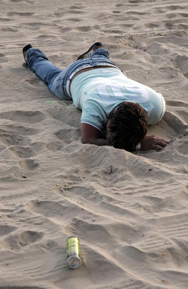 A man enjoys a snooze on the beach to kick off the new year in 2007. Picture: David Thomas.