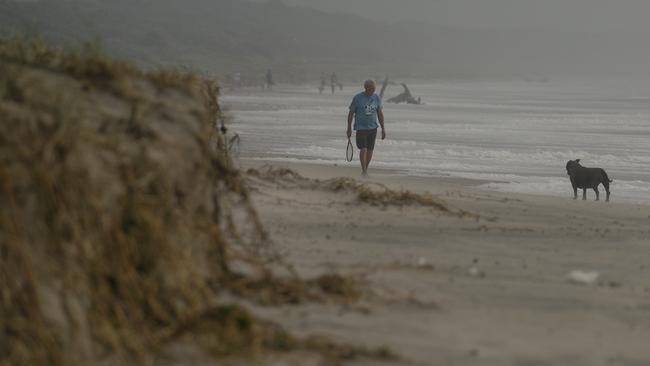 Locals get their exercise at 7 Mile Beach at Lennox Head on Thursday before three days of increasing rainfall and wind. Picture: Glenn Campbell