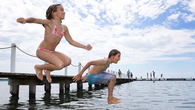 Julia Benedetti, 9, and brother Danny, 12, take a splash to cool down. Photo: Martin Lange