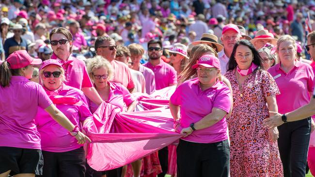 Volunteers carrying the huge banner emblazoned with Jane McGrath. Picture Thomas Lisson