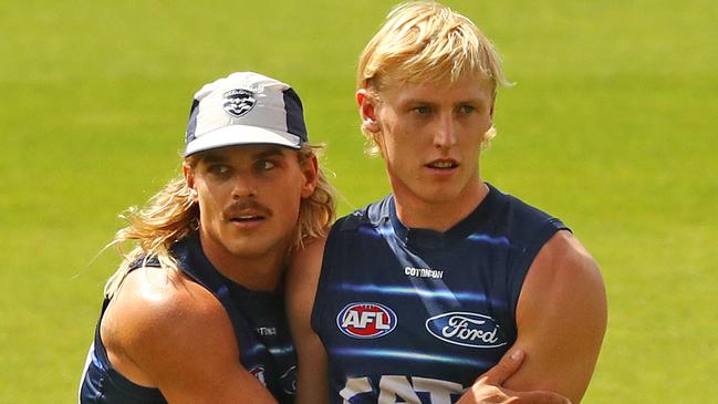 Bailey Smith gives Mitch Knevitt a hug at Geelong Cats training. Picture: Alison Wynd