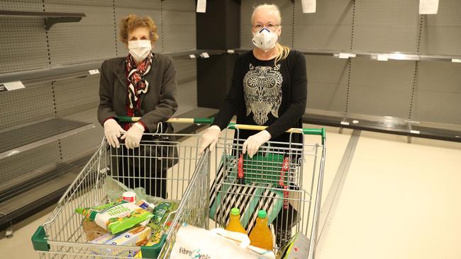 Denise Hinder and daughter Michelle Hinder-Smith find the shelves stripped bare at Woolworths in Crows Nest, Sydney. Picture Rohan Kelly