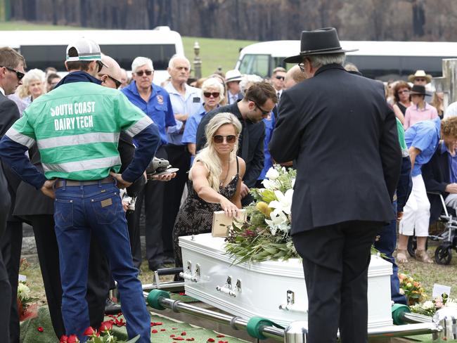 Renee Salway lays a photo on her husband Patricks's coffin. Picture: AAP