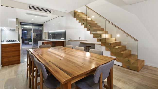 A study nook is built under the stairs.