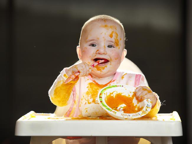 Ada Emmerson, seven months old, enjoys her mashed pumpkin, with some getting into her mouth. Picture: David Caird.