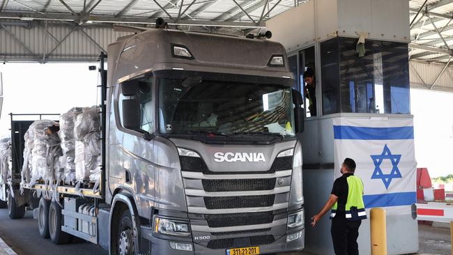 A truck carrying humanitarian aid drives through the Kerem Shalom crossing between southern Israel and the Gaza Strip on May 22 this year. Picture: AFP
