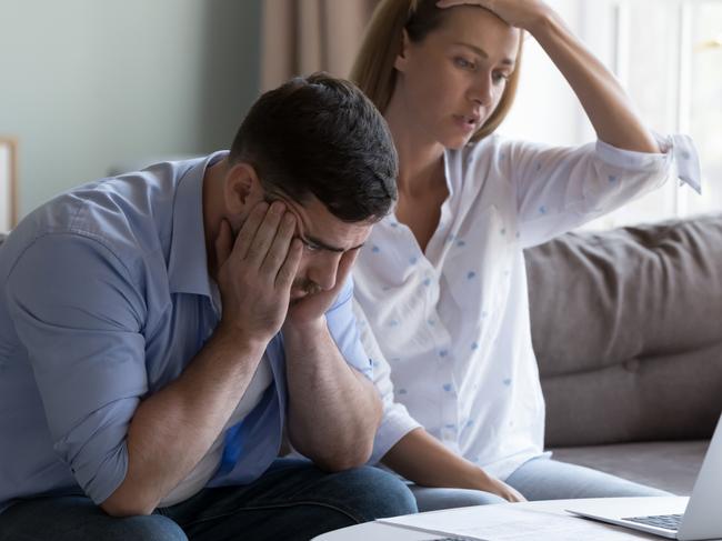 Stressed spouses manage family finances, analyze expenses, check savings and budget, looks disappointed due to mortgage arrears, unpaid utility bills, debt notice. Lack of money, high utility concept