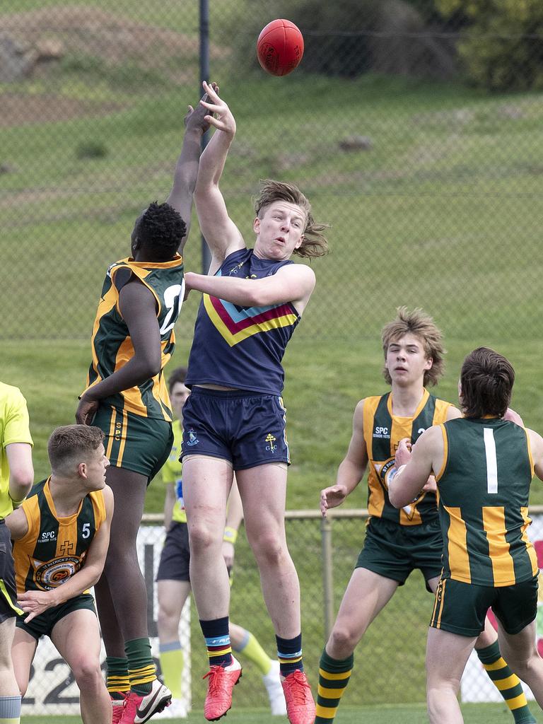 Guilford Young College’s Noah Holmes taps the ball down from a ruck contest. Picture: Chris Kidd