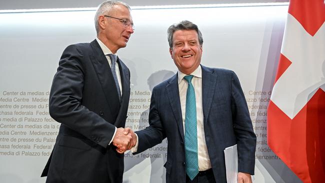 Credit Suisse chair Axel Lehmann shakes hands with his more buoyant UBS counterpart, Colm Kelleher. Picture: AFP