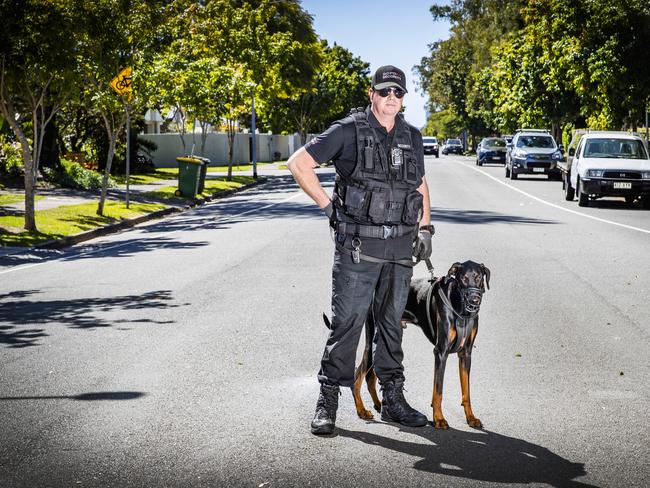 Security guard Wayne Heneker and his dog 'Boss', who has been hired by Gold Coast residents to patrol their suburbs. Picture: Nigel Hallett.