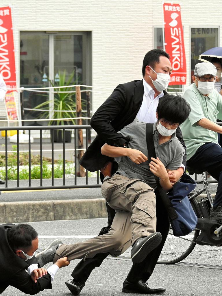 The alleged shooter is tackled by police after the shooting. Picture: Asahi Shimbun/AFP