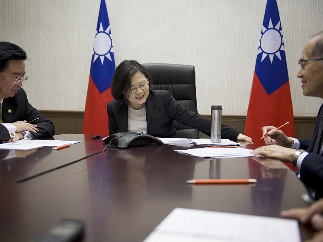 In this photo released by Taiwan Presidential Office President Tsai Ing-wen, centre, flanked by National Security Council Secretary-General Joseph Wu, left, and Foreign Minister David Lee, speaks with US President-elect Donald Trump through a speaker phone in Taipei. Picture: Presidential Office via AP