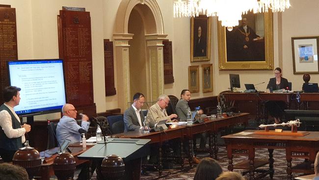 Cr Alexander Hyde (far left) discusses the pigeon at the Adelaide City Council meeting. Picture: Colin James