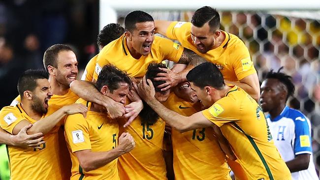 Socceroos players celebrate after Mile Jedinak scored against Honduras in their World Cup playoff match.