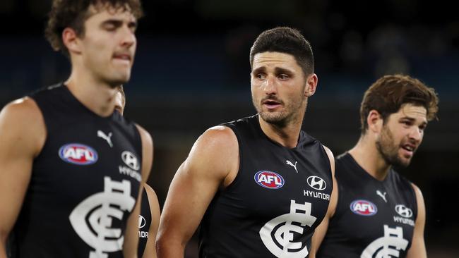 Marc Pittonet and teammates leave the field after a disappointing loss to Port Adelaide. Picture: Dylan Burns/AFL Photos via Getty Images