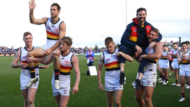 Crows players Tom Lynch, Rory Sloane, David Mackay and Daniel Talia chair off retiring players Richard Douglas and Andy Otten. Picture: Quinn Rooney/Getty Images