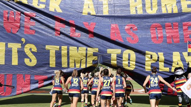 The Crows run through the banner for their first home game of the season. Picture: Sarah Reed.