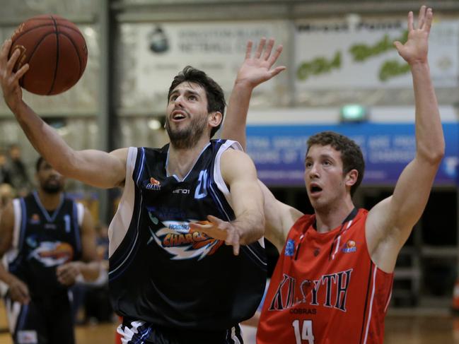 BASKETBALL:  Hobart Chargers v Kilsyth, Hobart Netball and Sports Centre: Chargers' Jarrad Weeks goes for a lay up over Kilsyth's Michael Knoll Picture: LUKE BOWDEN