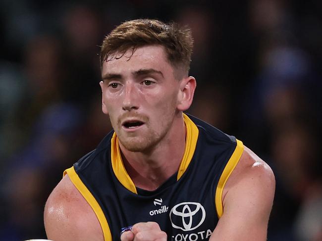 ADELAIDE, AUSTRALIA - JUNE 06: Mark Keane of the Crows handpasses the ball during the 2024 AFL Round 13 match between the Adelaide Crows and the Richmond Tigers at Adelaide Oval on June 06, 2024 in Adelaide, Australia. (Photo by James Elsby/AFL Photos via Getty Images)