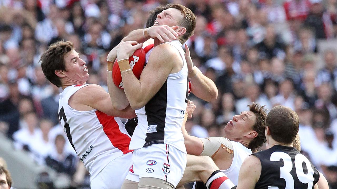 Brendon Goddard takes a spectacular grab alonside Lenny Hayes in the 2010 decider.