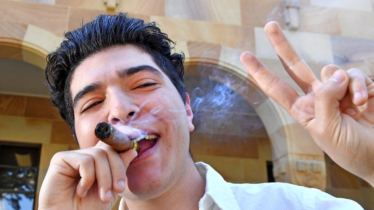 Drew Pavlou lights a cigar at the University of Queensland to celebrate the announcement of the federal inquiry into foreign interference at universities. Picture: NewsWire/John Gass.