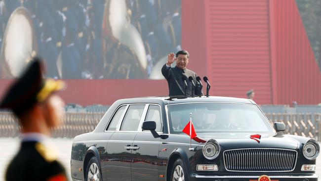 Xi Jinping waves from a vehicle as he reviews the troops at a military parade in Beijing. REUTERS/Thomas Peter